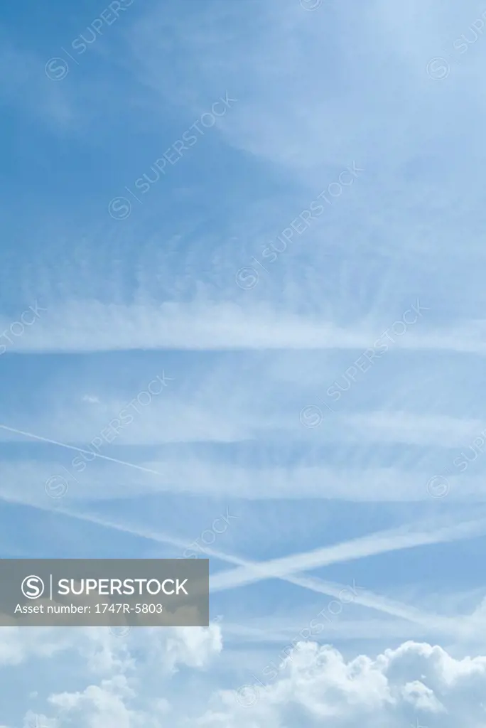 Sky with clouds and vapor trails