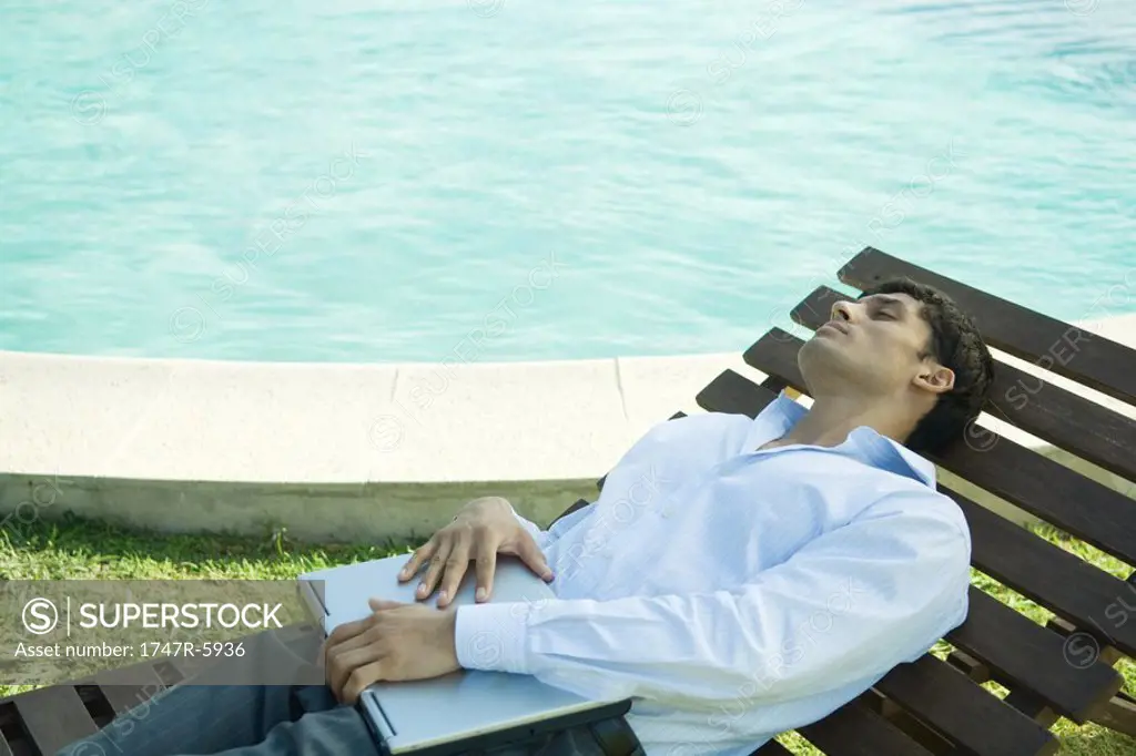 Businessman reclining on lounge chair