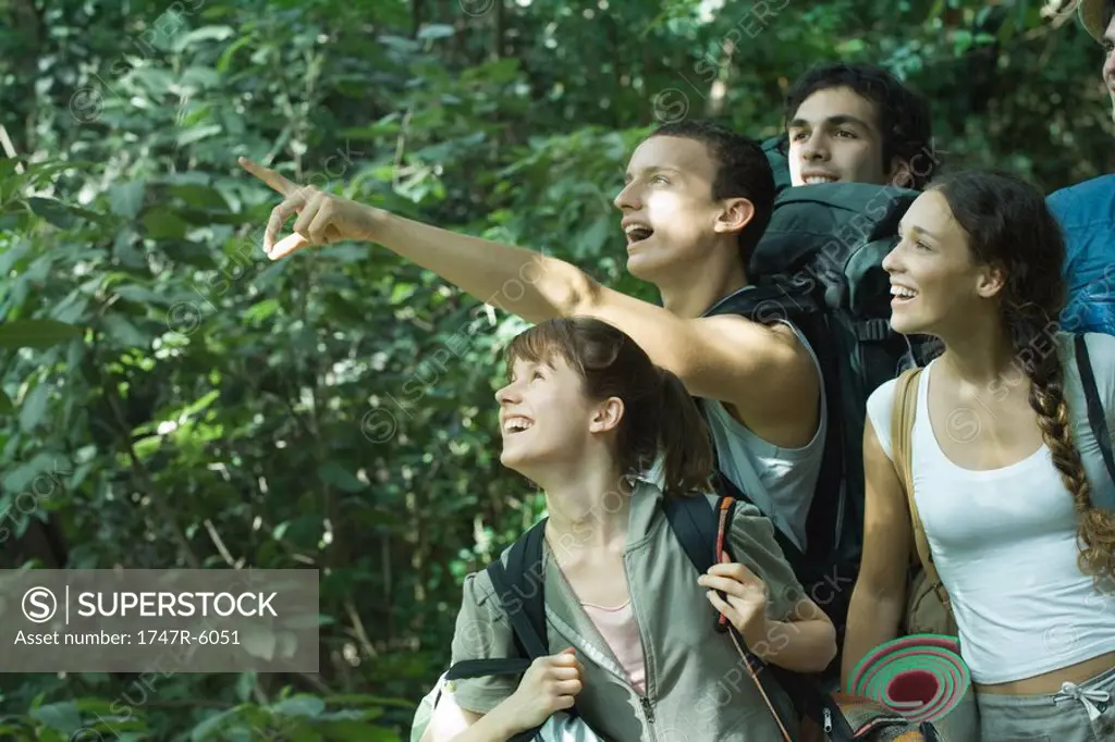 Group of hikers, one pointing to distance