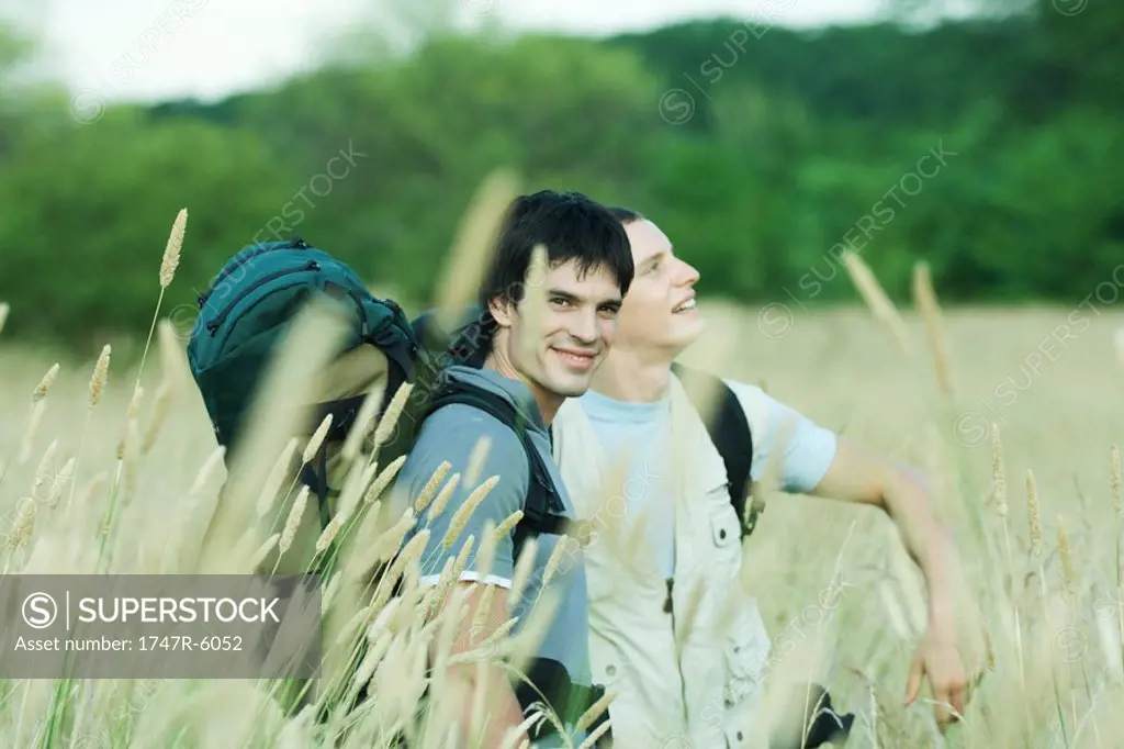Two hikers standing in field