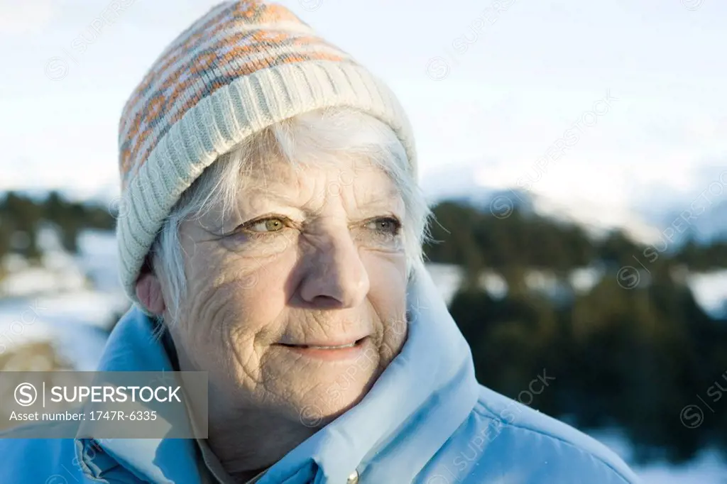 Senior woman in snowy landscape, head and shoulders