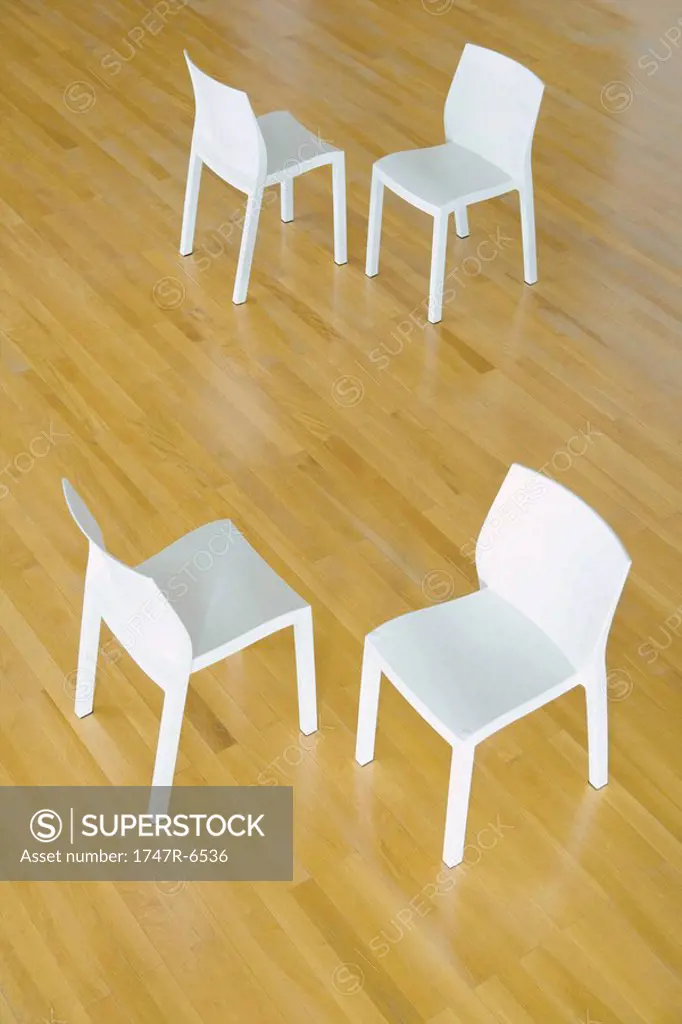 Two pairs of chairs on hardwood floor, high angle view