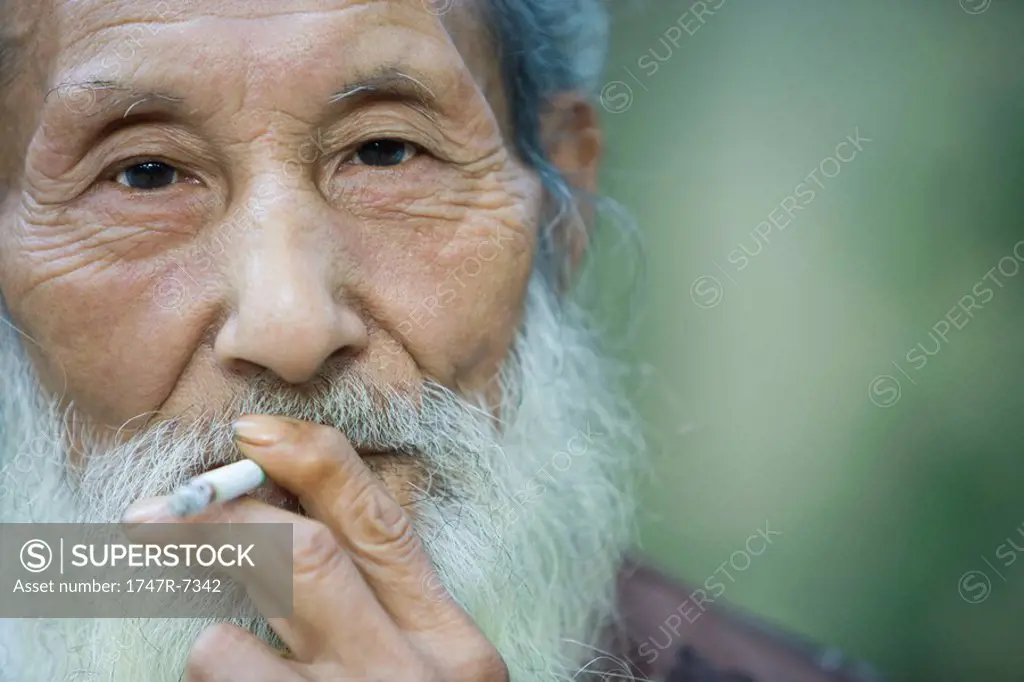 Elderly man smoking cigarette
