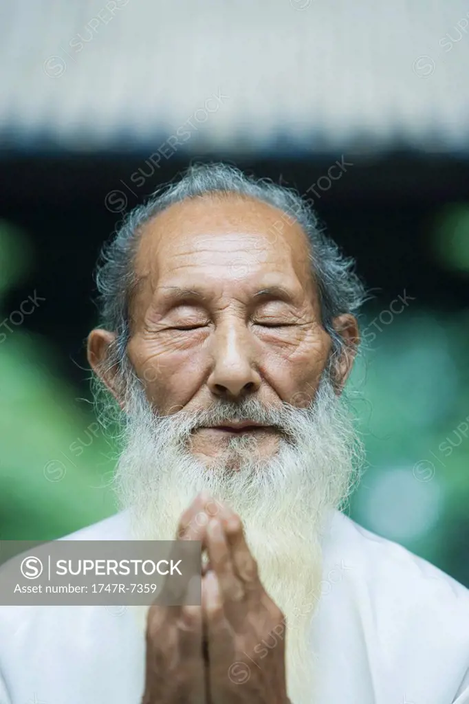 Elderly man praying