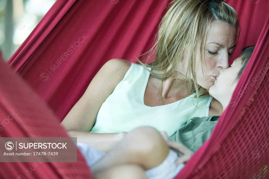 Boy and mother in hammock, kissing