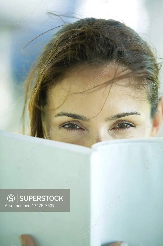 Woman looking over book