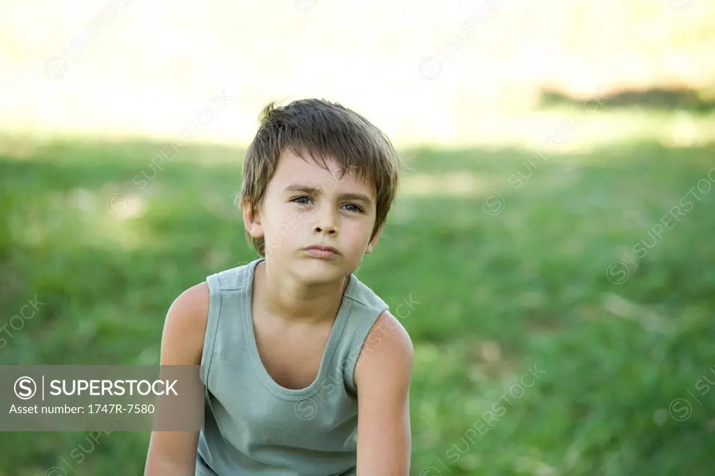 Little boy outdoors, looking away, portrait