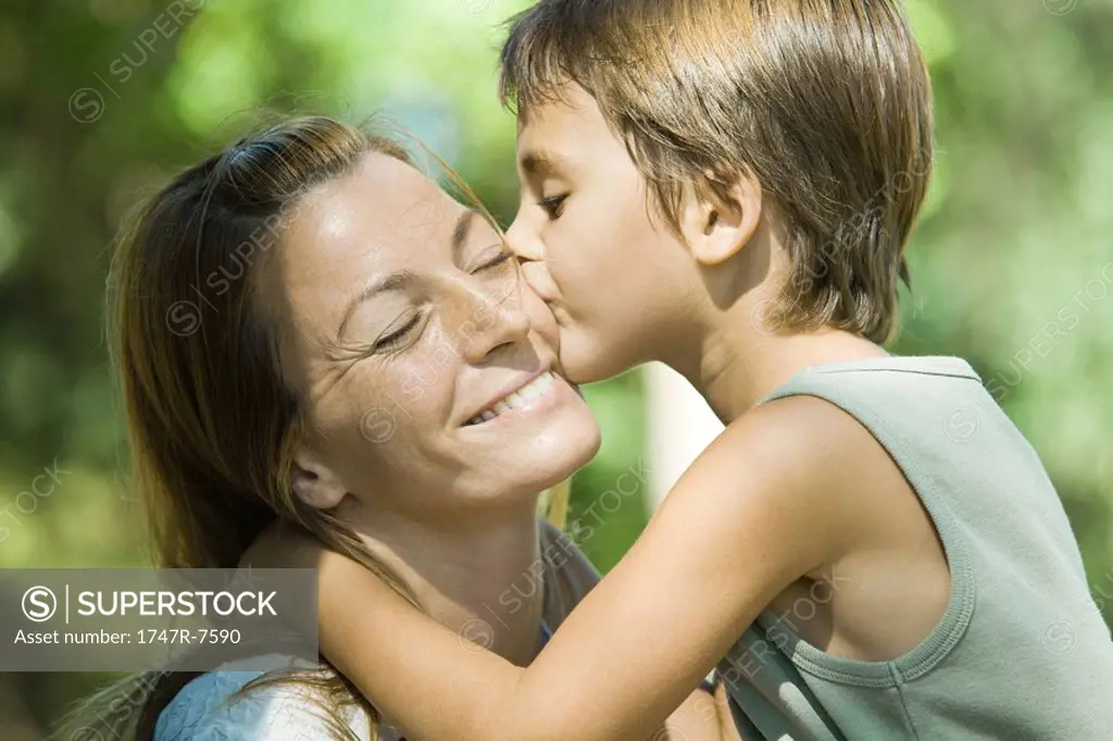 Mother and son, boy kissing woman on cheek, close-up