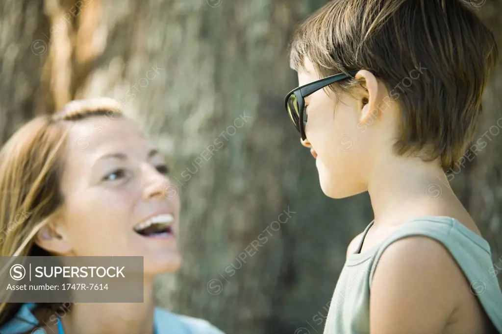Mother and son, boy wearing sunglasses, woman laughing