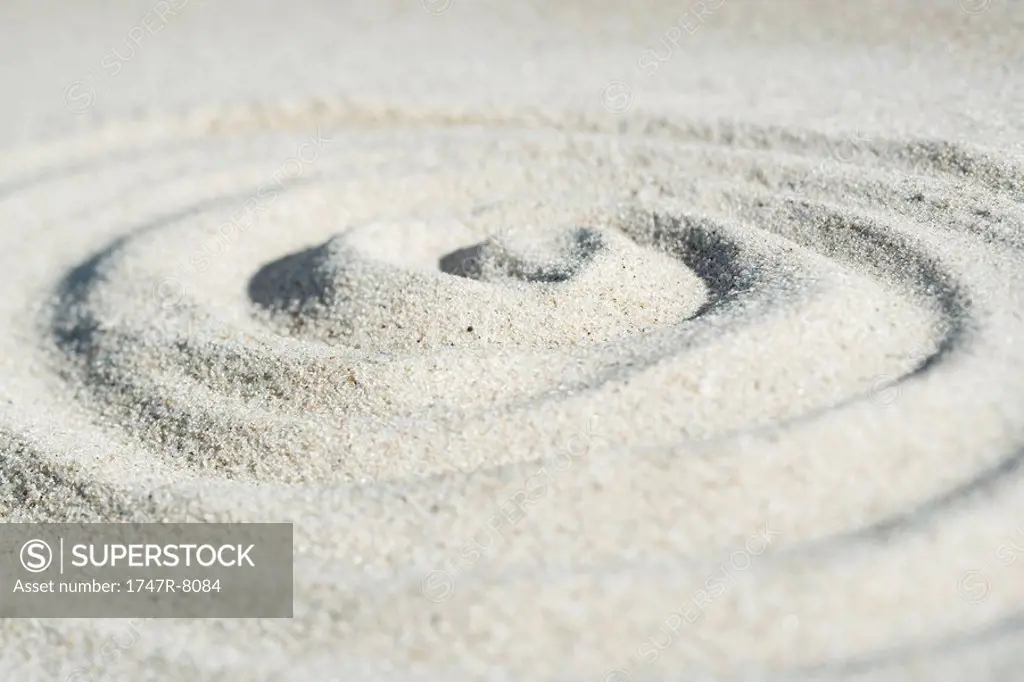 Spiral shape drawn in sand, close-up