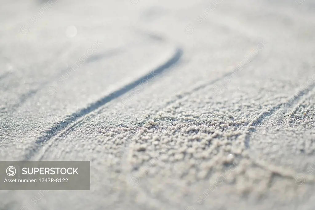 Pattern traced into sand, full frame, extreme close-up
