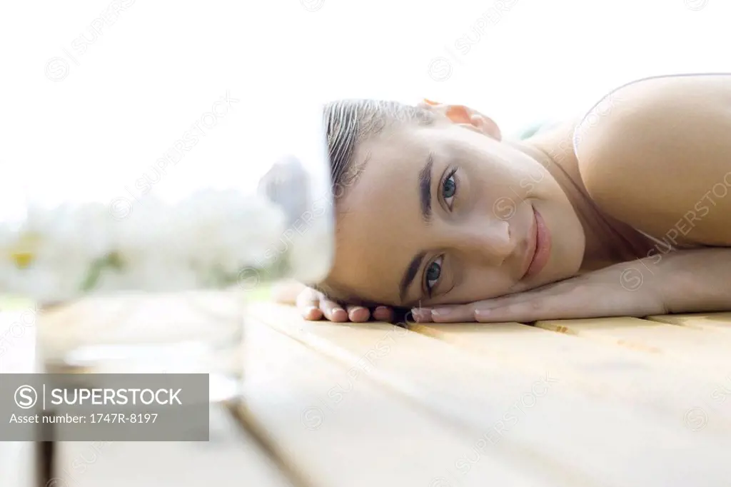 Woman lying on deck, smiling