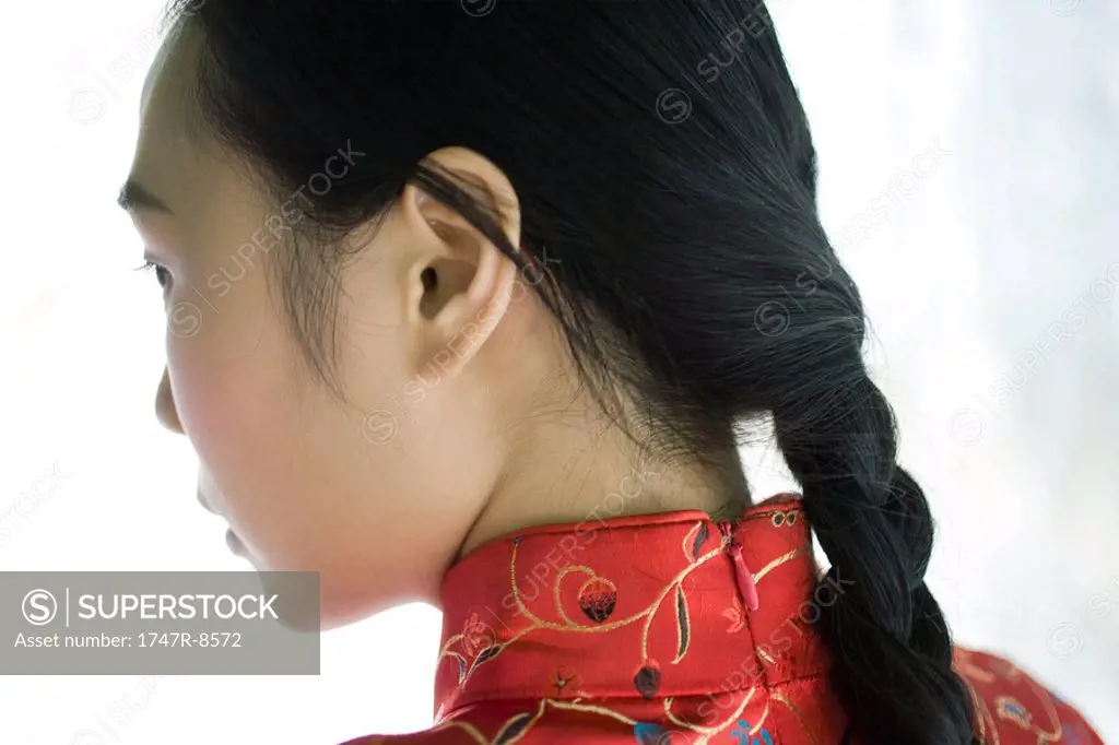 Young woman with hair braided, close-up, rear view