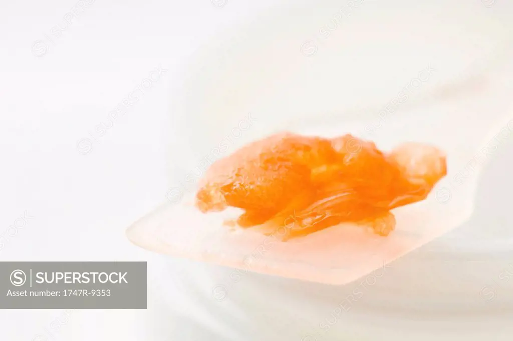 Orange flesh on spatula, close-up