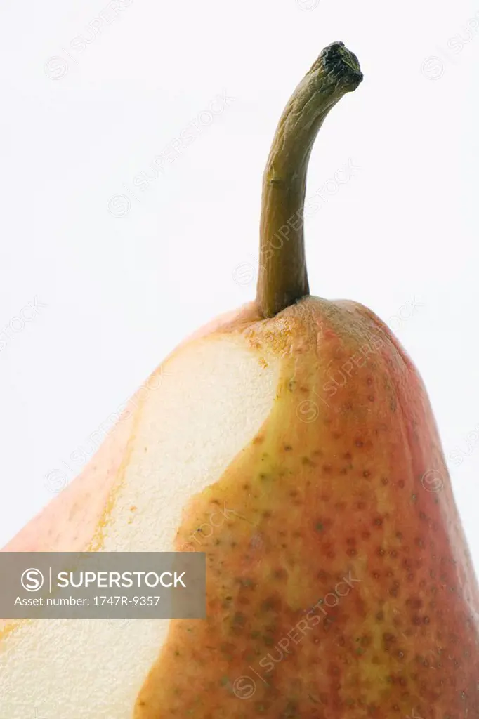Fresh pear, partially peeled, close-up, cropped
