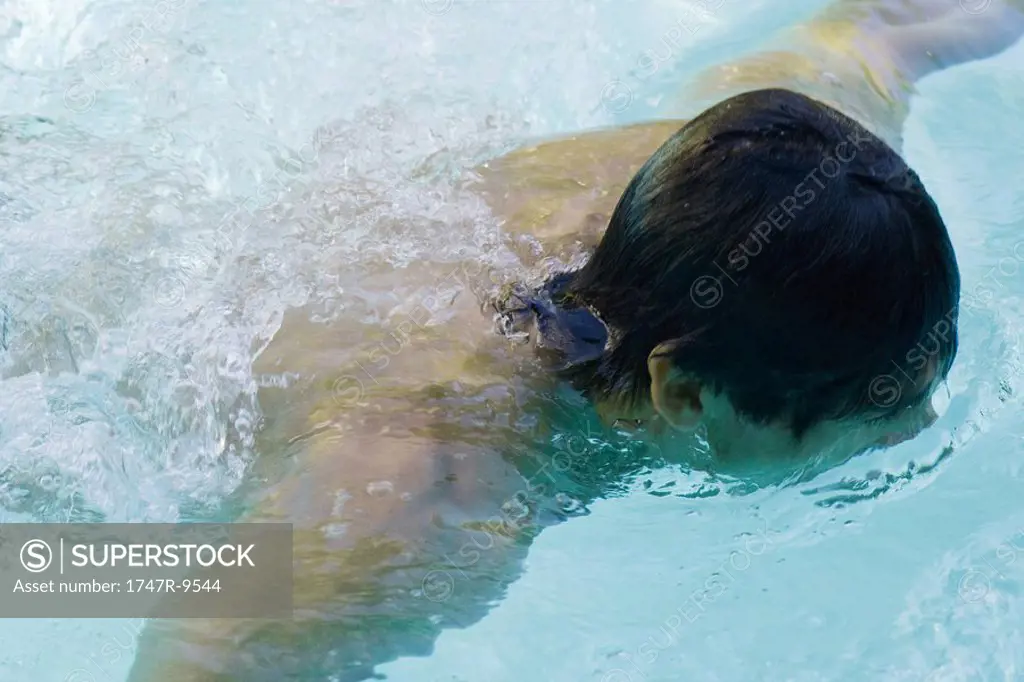 Man swimming in pool, high angle view, close-up