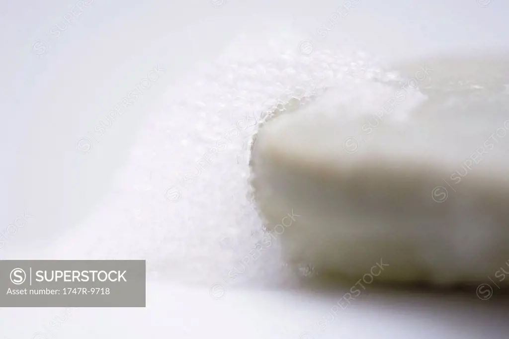 Bar of soap and soap suds, close-up