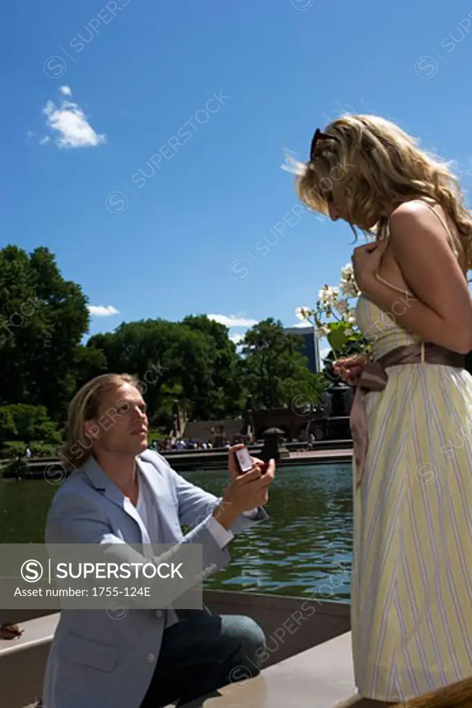 Young man proposing to a young woman in a boat, Central Park, Manhattan, New York City, New York, USA