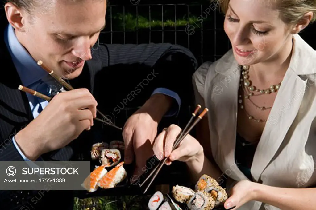 Young couple eating sushi