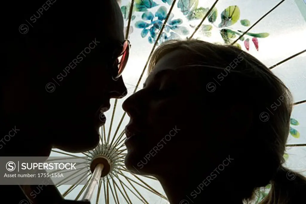 Silhouette of a young couple kissing each other