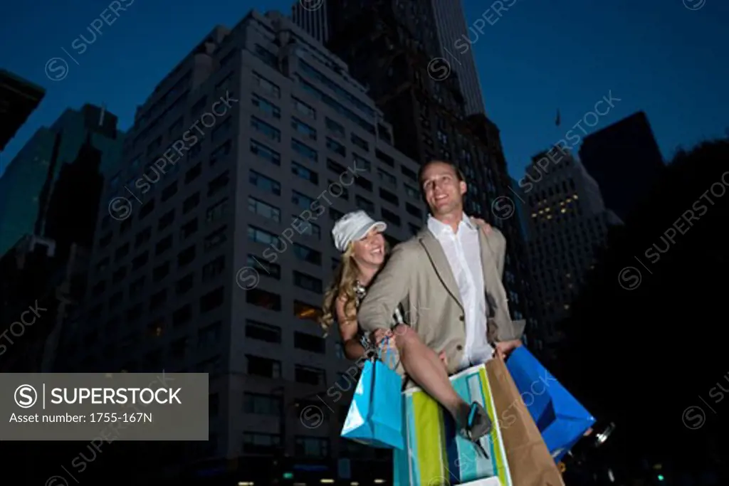 Young woman riding piggyback on a young man, New York City, New York, USA