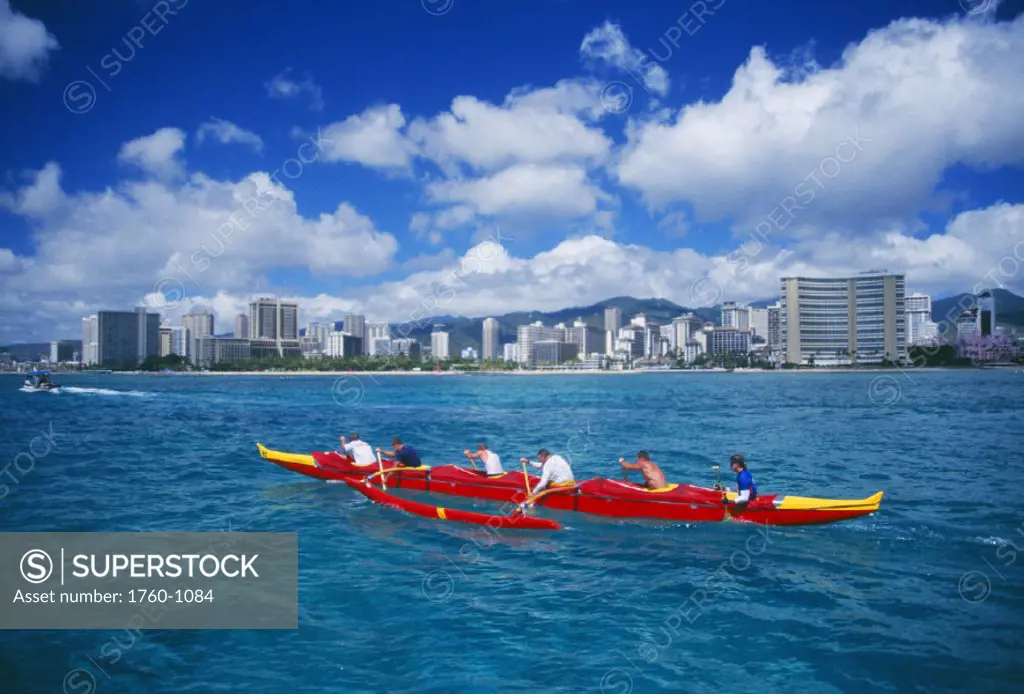 Hawaii, Oahu, Molokai to Oahu canoe race, outrigger canoe team in front of Waikiki beach.