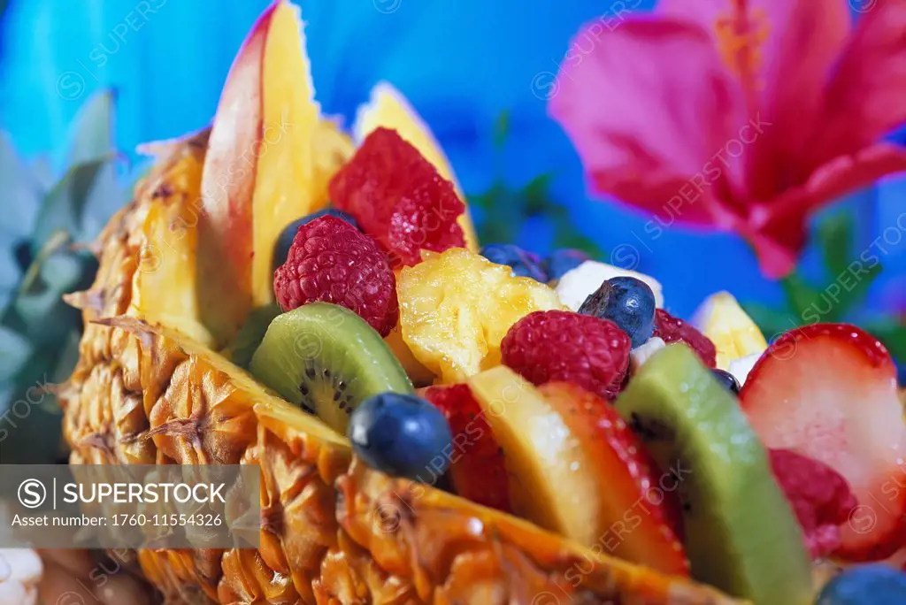 Fresh Fruit Salad Served In Half Pineapple, Colorful Variety, Hibiscus Flower Background