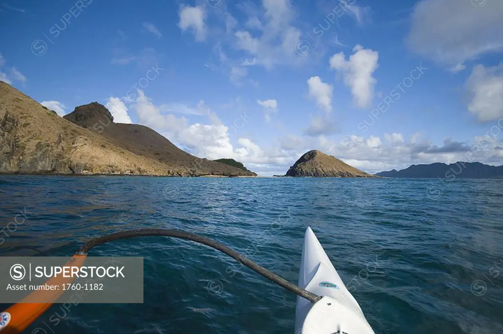 Hawaii, Oahu, Bow of one man canoe paddling towards Mokulua Islands