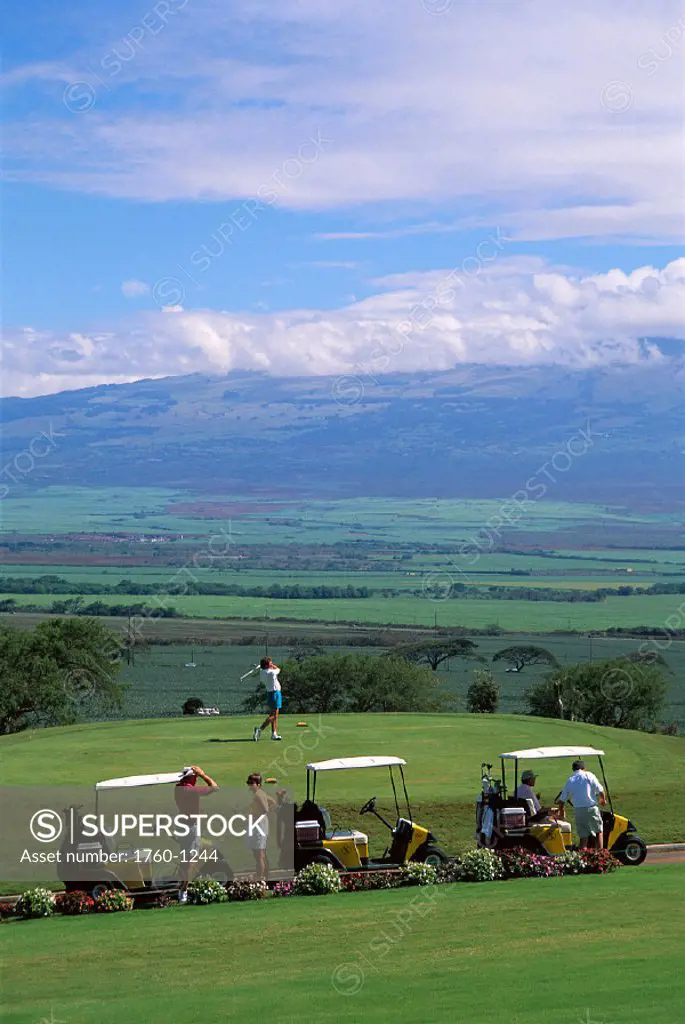 Golfing on Maui Sandalwood Golf Course, Hawaii golf carts lined up B1270