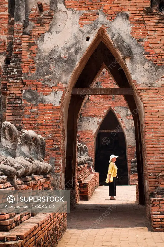 Thailand, Ayutthaya, Woman visitor at Wat Chai Watthanaram Buddhist temple ruins.