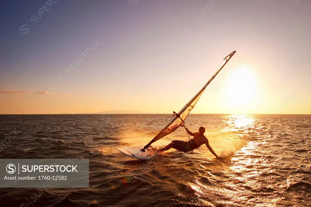 Hawaii, Maui, Kihei, Windsurfer sailing off the coast of south Maui at sunset