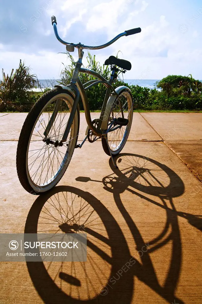 Hawaii, Kauai, Kealia Beach, Bike parked on bike path, beautiful shadow.