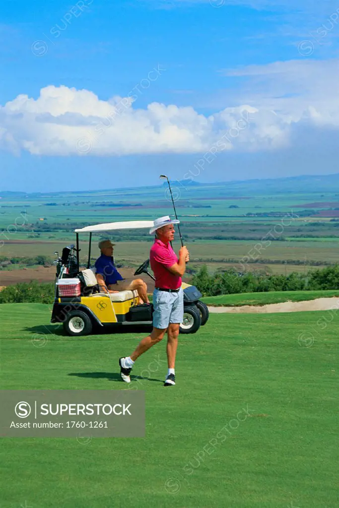 Hawaii, Maui, Sandalwood GC, C/u of man teeing off, other man sits in golf cart C1258