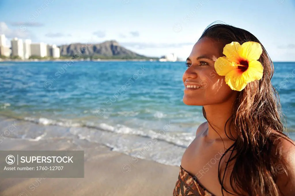 Hawaii, Oahu, Beautiful Local Polynesian Female smiling on waikiki beach with Diamond Head in background