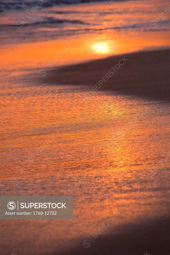 Hawaii, Maui, Makena, Sunset light is reflected on the sand at Makena Beach