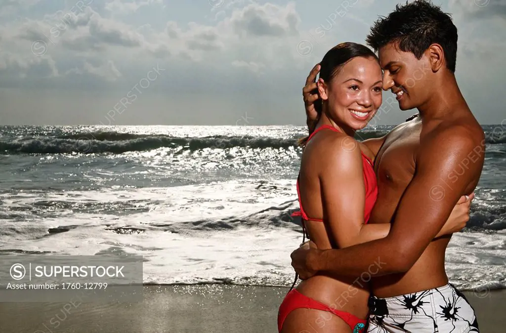 Hawaii, Kauai, Kealia Beach, Beautiful couple on the beach having fun.