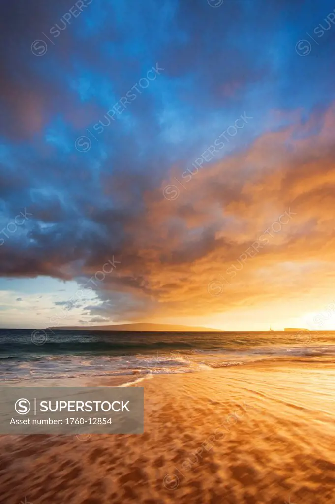 Hawaii, Maui, Makena, Wave washes over sand at Makena Beach at Susnet