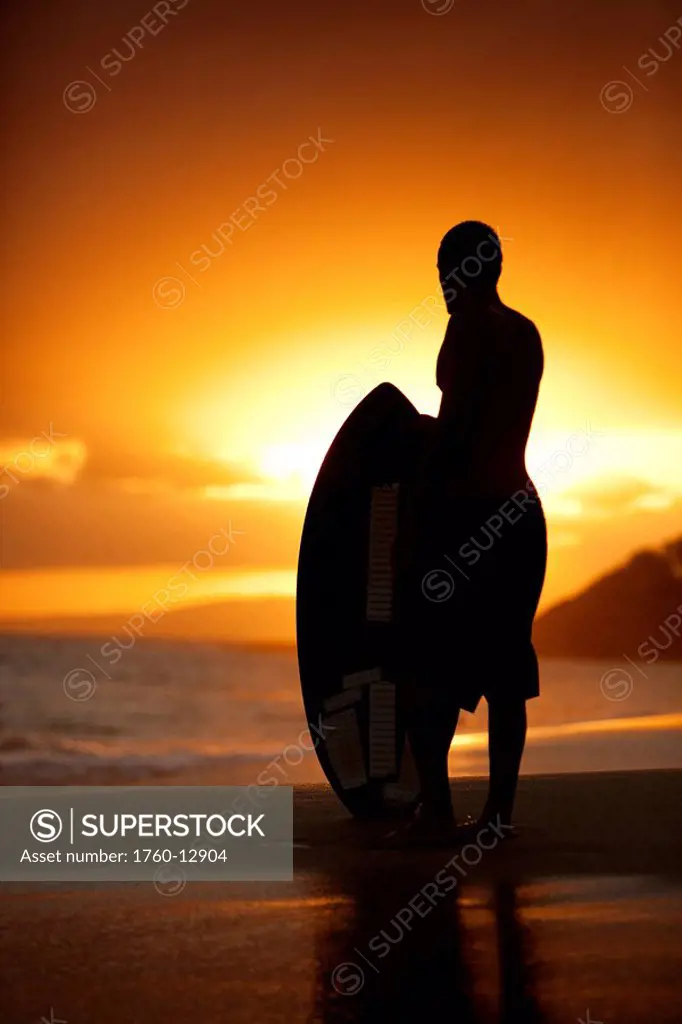 Hawaii, Maui, Makena, Skimboarder silhouette at sunset
