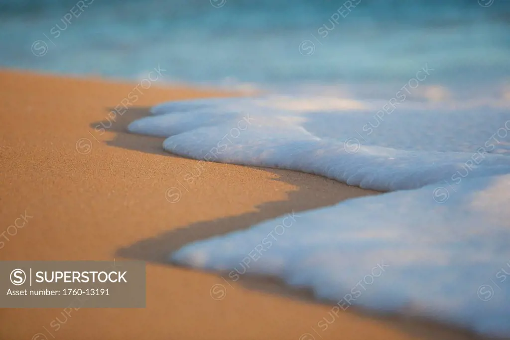 Hawaii, Maui, Makena, Sea foam over sand at sunset