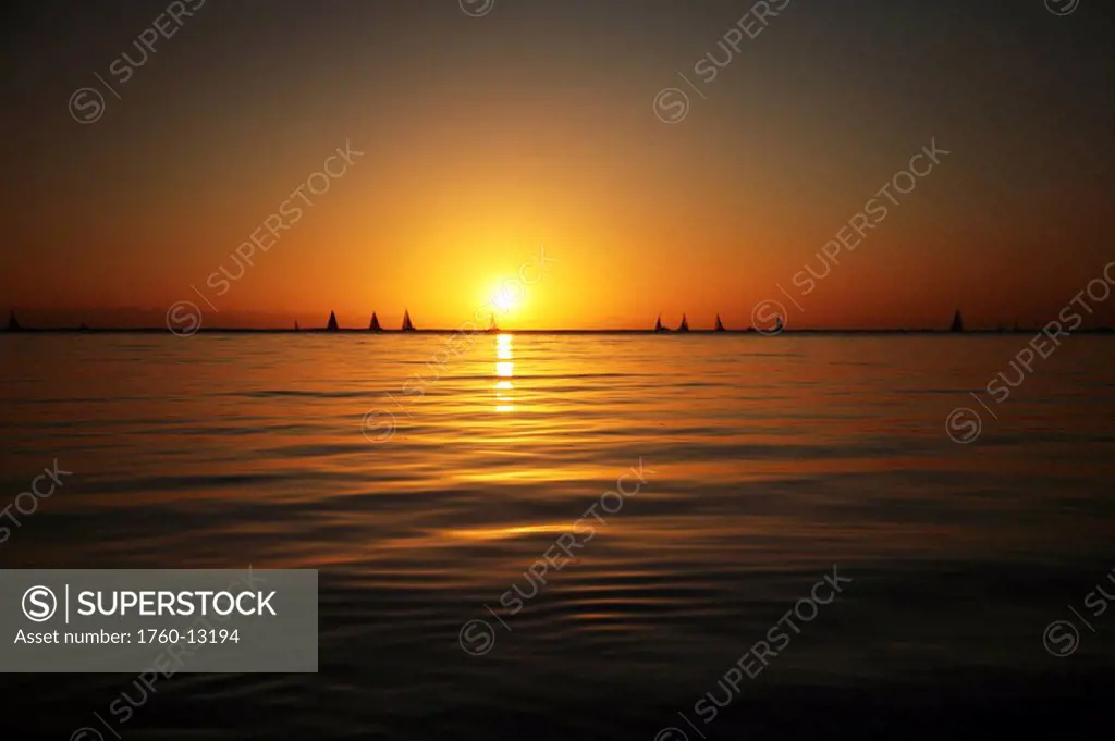 Hawaii, Oahu, Beautiful sunset over the ocean with sailboats in the distant