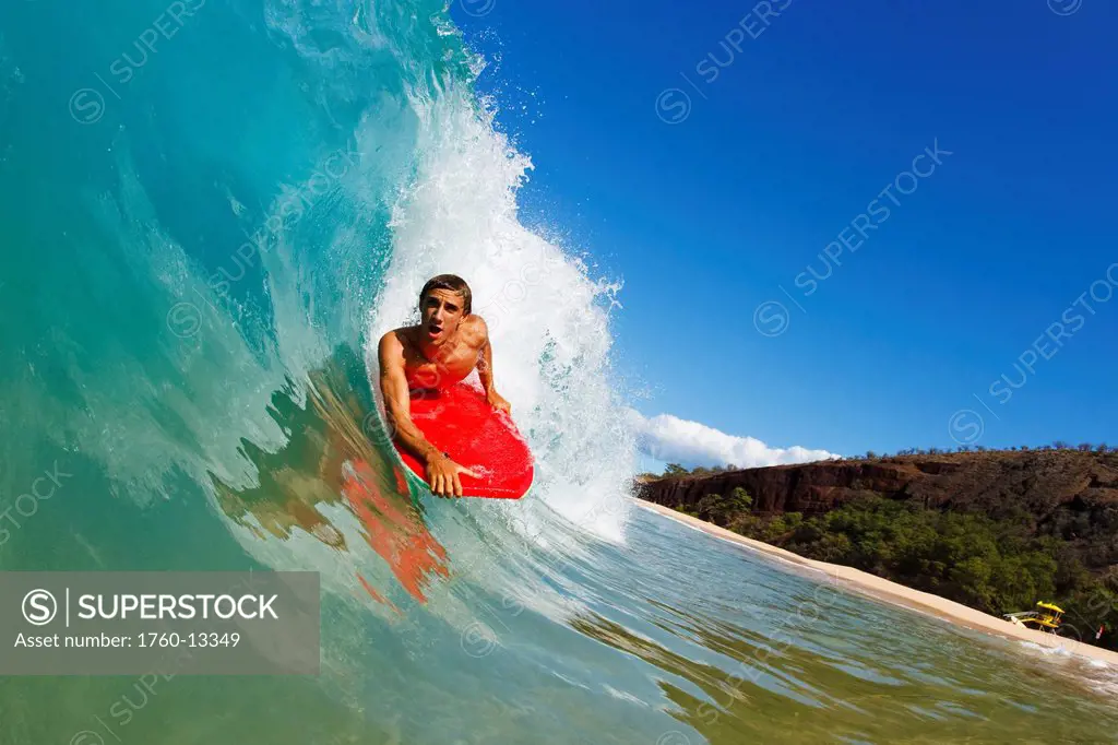 Hawaii, Maui, Makena _ Big Beach, Young man boogie boarding on beautiful wave.