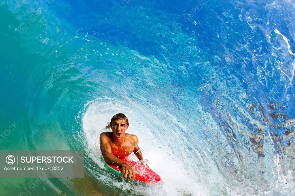 Hawaii, Maui, Makena _ Big Beach, Boogie boarder riding barrel of beautiful wave.