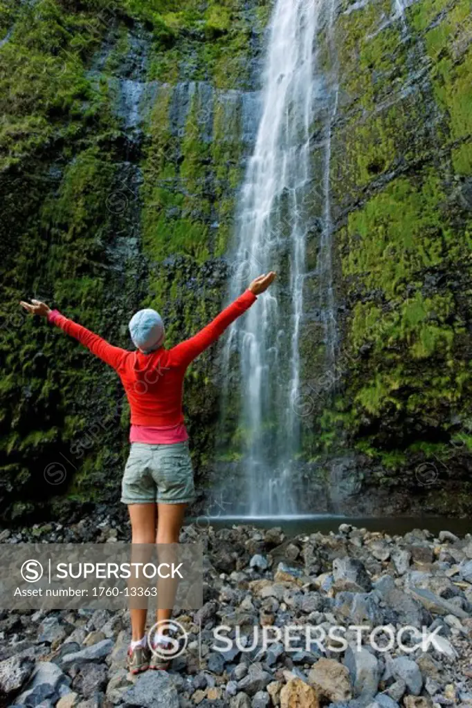 Hawaii, Maui, Waimoku Falls, Female hiker at base of waterfall.