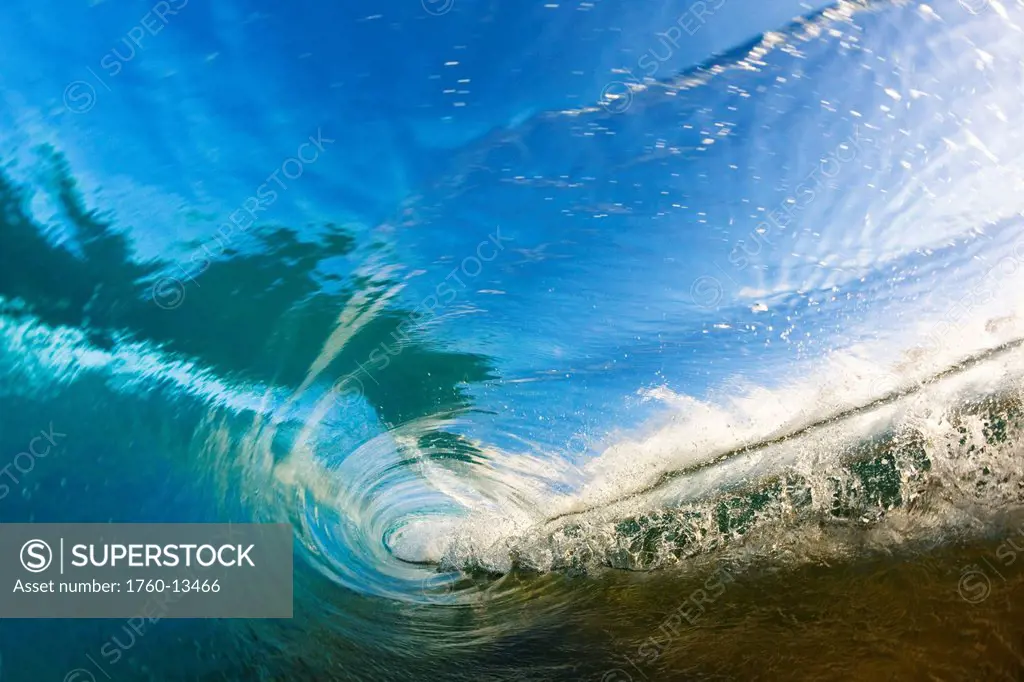 Hawaii, Maui, Makena, View through tube of glassy wave at sunrise.