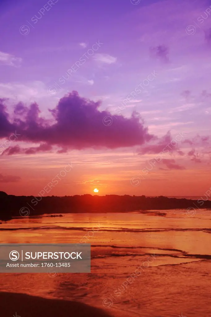 Hawaii, Purple and orange sunset over coast.