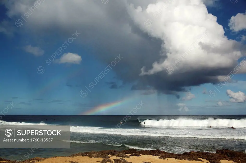 Hawaii, Oahu, Rocky Point, rain and rainbows above ocean.