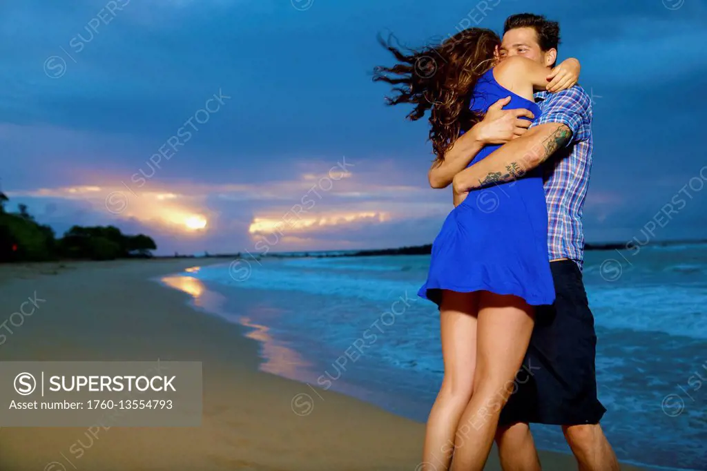 Couple on a beach; Kealia, Kauai, Hawaii, United States of America