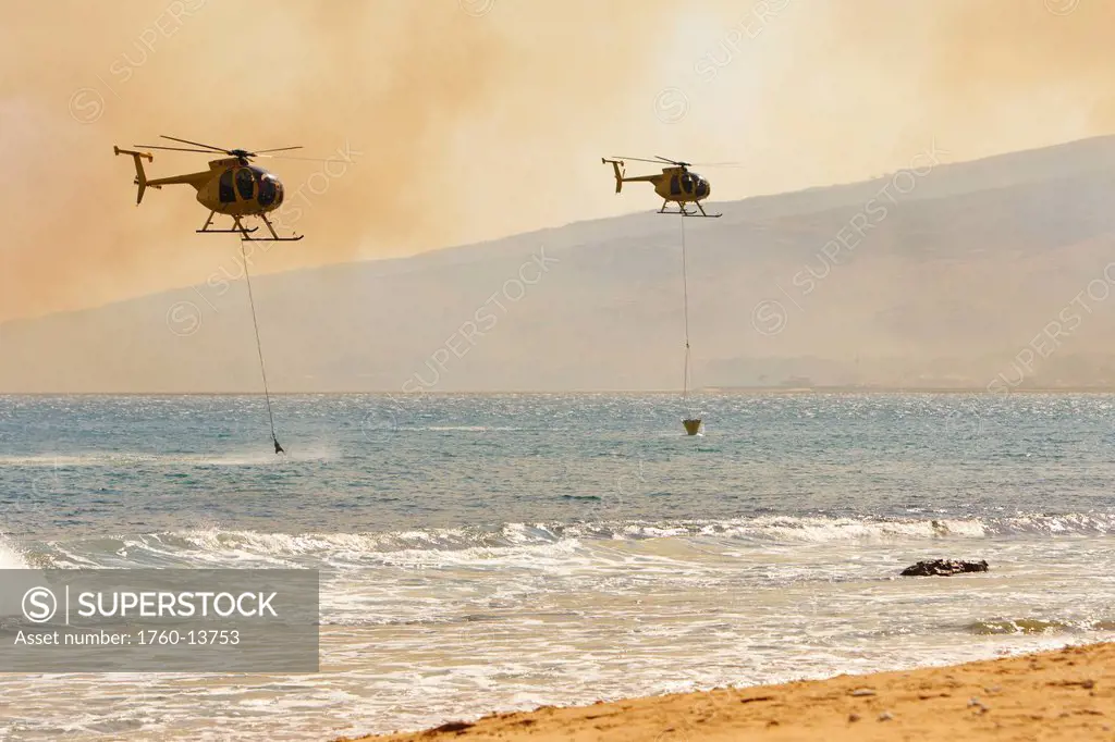 Hawaii, Maui, Ma´alaea, Fire helicopters collecting ocean water to help put out wildfire. Editorial Use Only.
