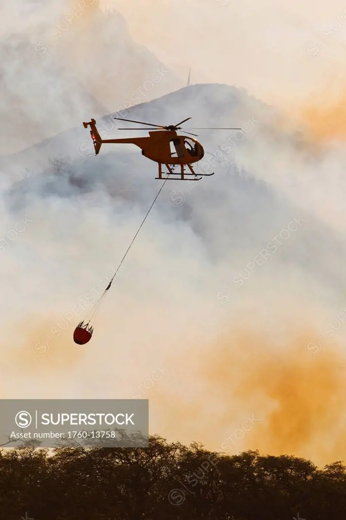 Hawaii, Maui, Ma´alaea, Fire helicopter dropping ocean water on wildfire. Editorial Use Only.