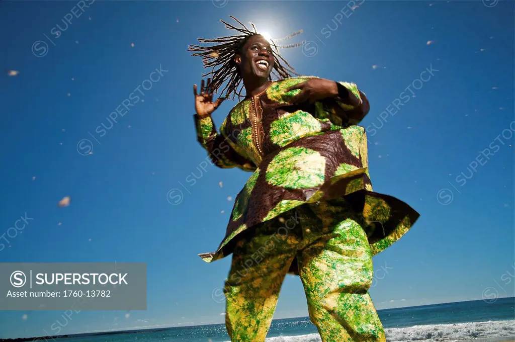 Hawaii, Kauai, Kealia Beach, African dancer on shore.